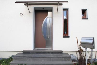 kupferfarbene-aluminium-haustuer-mit-ovalem-lichtausschnitt