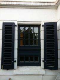 Dunkelgraues Sprossenfenster mit Fensterläden